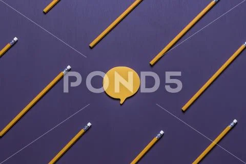 Speech bubble surrounded by wooden pencils Stock Photos