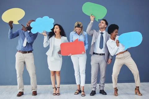 Speech bubble, team and comment by business people holding sign, news and voice Stock Photos