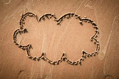 A speech cloud or think bubble drawn out on a sandy beach. Beach background. Foto stock