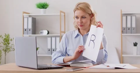 Speech therapist or language teacher gives online lesson and teaches student to Stock Footage 283914899