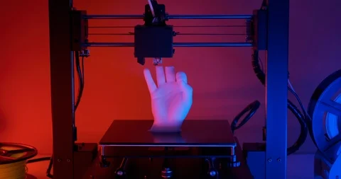 Speed 3D printer prints model hands fingers ok sign closeup red blue neon light. Stock Footage 126408515