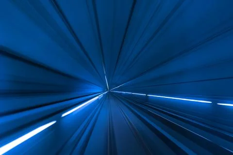 Speed blurred motion of train or subway train moving inside tunnel. Stock Photos