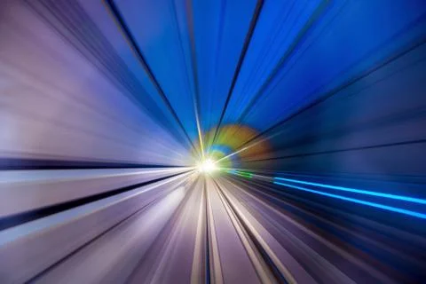 Speed blurred motion of train or subway train moving inside tunnel. Stock Photos