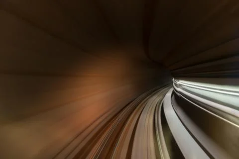 Speed blurred motion of train or subway train moving inside tunnel. Stock Photos
