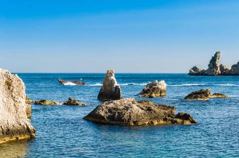 Speed boat and sharp rocks near Isola Bella Stock Photos