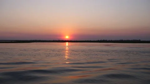 Speed boat and sunset scene in the Okavango Delta, Botswana Stock Footage 135585488