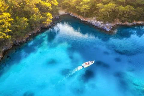 Speed boat in blue sea at sunrise in summer. Aerial view Stock Photos