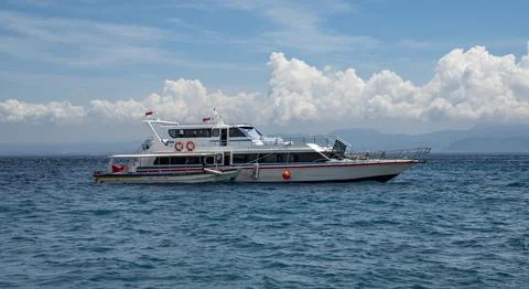Speed boat going into ocean with clouds in the sky Stock Photos