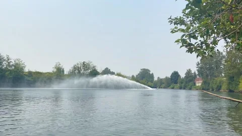 Speed boat moving along the river with big fountain Stock Footage 272209774