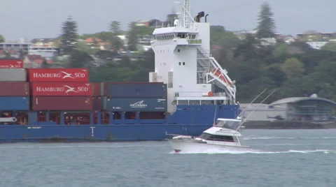 Speed boat passing container ship Stock Footage 43794037