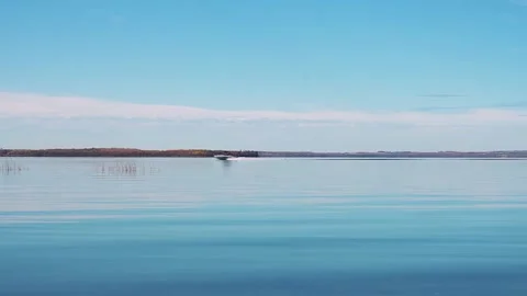 Speed boat passing right to left on calm blue water Video stock 163057980