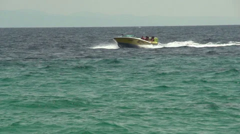 Speed boat pulling people on the rubber floater slow motion Stock Footage 32846803