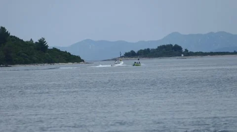 Speed Boat Pulls People for Fun on Sea Stock Footage 54896730