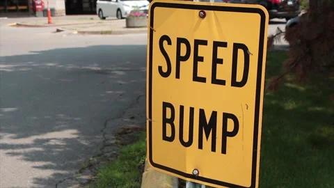 Speed bump caption text writing rectangle metal sign with still parking lot Stock Footage 247144101