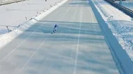 Speed Ice Skater Skating On Outdoor Race Hd Aerial Video. Flying Over Athlete Stock Footage