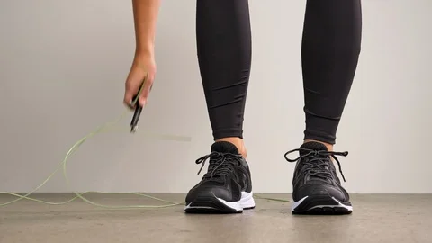 Speed jump rope on ground picked up by athlete Video stock 105129899