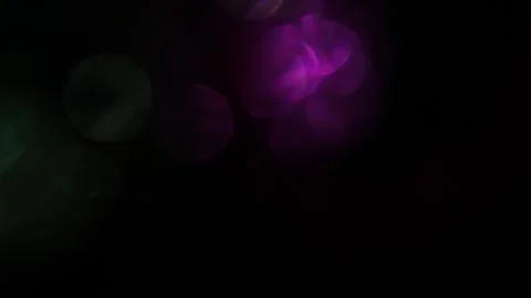 Speed ​​of light, bright purple and green bokeh on the left in the blackness 스톡 동영상 317461861