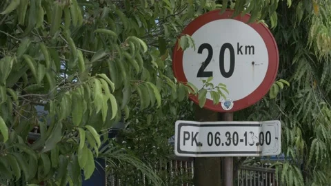 Speed limit 20 km/h traffic sign with time, Indonesian road signage Stock Footage 139330592