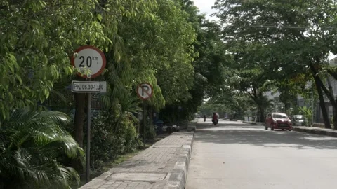 Speed limit 20 km/h traffic sign with time in the street sidewalk Stock Footage 139333430