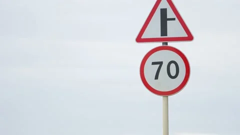 Speed limit on the road. 70 km per hour. Crossroads. Slow down. A sign shows a Stock Footage 188253013