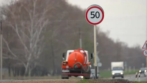 Speed limit sign 50 km on the road with many vehicles. Reduce speed. Safety Stock Footage 192901936