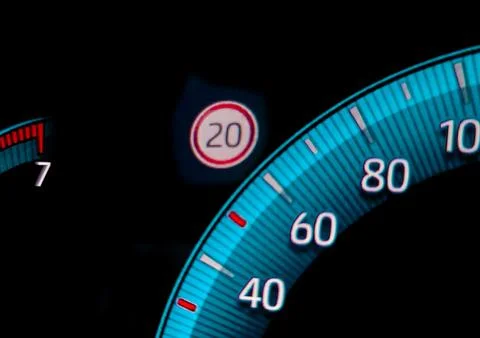 Speed limit warning close to speedometer indicator Stock Photos