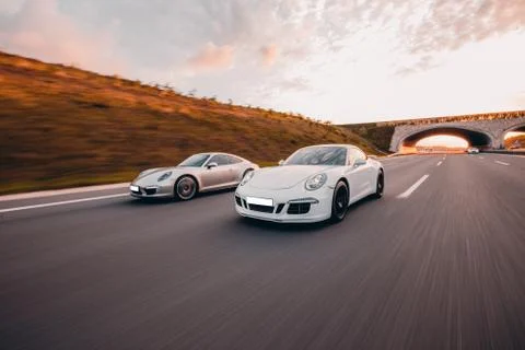 Speed motion between two sport cars in the dusk time Stock Photos