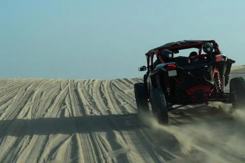 Speed motion blur of a dune buggy carving through sand tracks  Фото