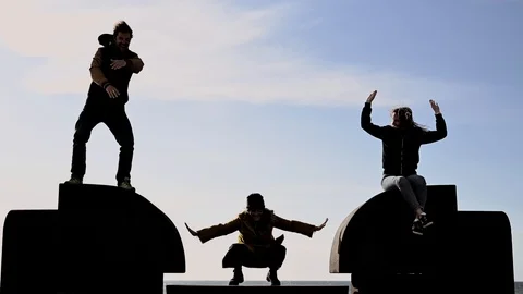 Speed motion of crazy funny uncoordinated  three  people dancing outdoor Stock Footage 105897294