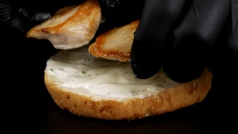 Speed up process of chef making a Chicken Burger with bacon, closeup Stock Footage 75253821