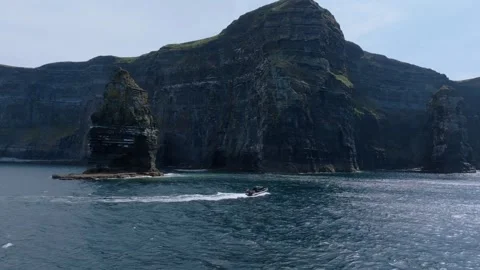 Speed RIB Cutting Wake Below Steep Cliffs of Moher Sea Stacks Stock Footage 341019132