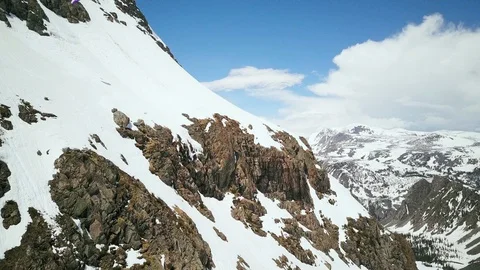 Speed rider starting dangerous flight from rocky mountainside, Wyoming USA Stock Footage 124222704