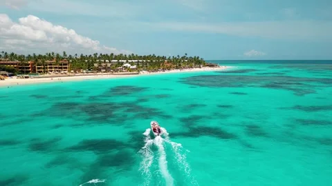 A speedboat cuts through the crystal-clear water, scene of tropical paradise Stock Footage 278705117