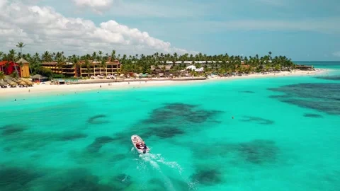 A speedboat cuts through the crystal-clear water, scene of tropical paradise Stock Footage 278705137