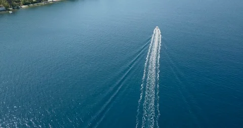 Speedboat leaving trace on sea surface by the coastline Stock Footage 107954932
