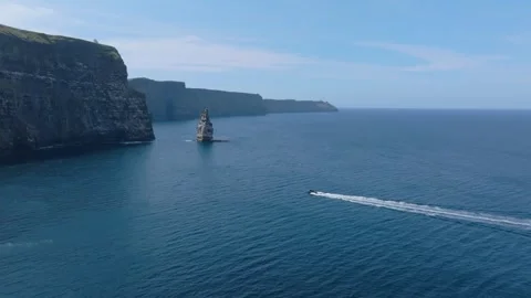 Speedboat Leaving White Wake Below Ireland Sea Cliffs, Aerial Wide Shot Stock Footage 341019576