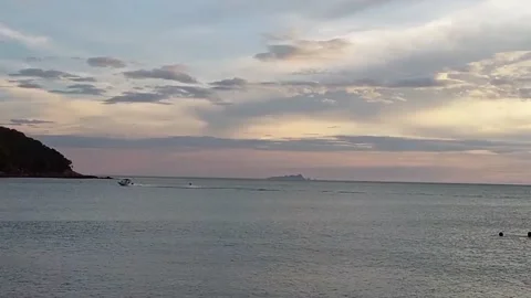 A speedboat passing by the beach Stock Footage 139936038