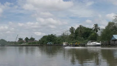 Speedboat passing through unfunctional old port of Banjarmasin Stock Footage 142123413