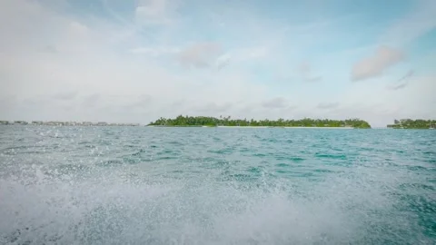 Speedboat Point-of-View Approaching Tropical Island Resort with Overwater Villas Stock Footage 342278878
