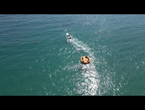 Speedboat pulling inflatable - Coral Bay Paphos Stock Footage 284783261