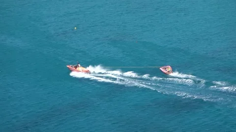 Speedboat pulls at high speed an inflatable surface Video stock 141779422