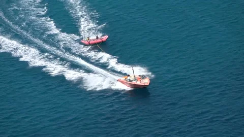Speedboat pulls at high speed an inflatable surface Video stock 141780346