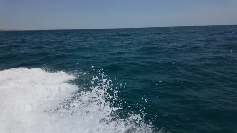 Speedboat racing through ocean off the coast of Albufeira Algarve Stock Footage 310321438