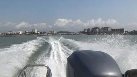 A speedboat running on the sea creates waves at its stern Stock Footage 332288294