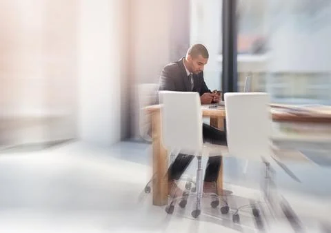 Speeding up business tasks using smart technology. a young businessman using his 스톡 사진