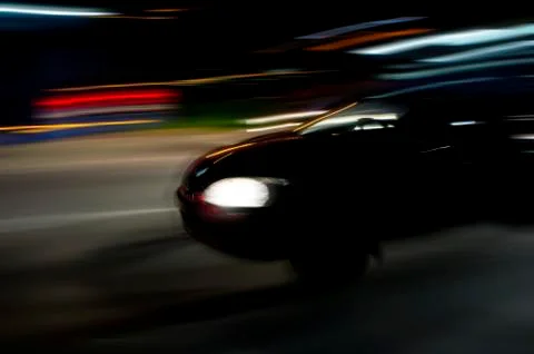 Speeding car in the dark Stock Photos