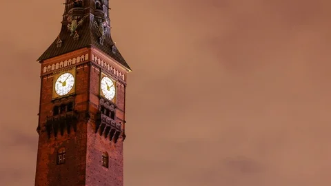 A speeding clock face in a city in timelapse, lit by artificial lighting Stock Footage 97556266