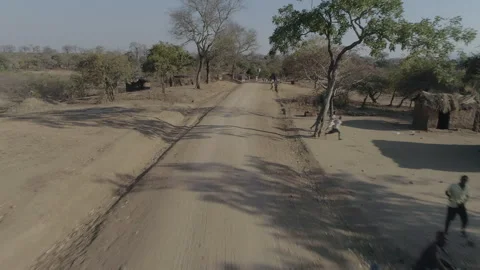 Speeding down village road in Malawi, Africa Stock Footage 276111592