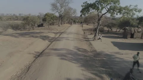 Speeding down village road in Malawi, Africa LOG Stock Footage 276111891