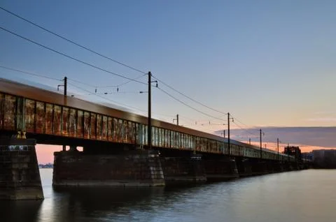 Speeding freight train on rusty bridge Stock Photos